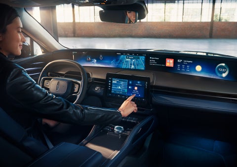 The driver of a 2025 Lincoln Nautilus® SUV interacts with the center touchscreen. | Star Lincoln in Southfield MI